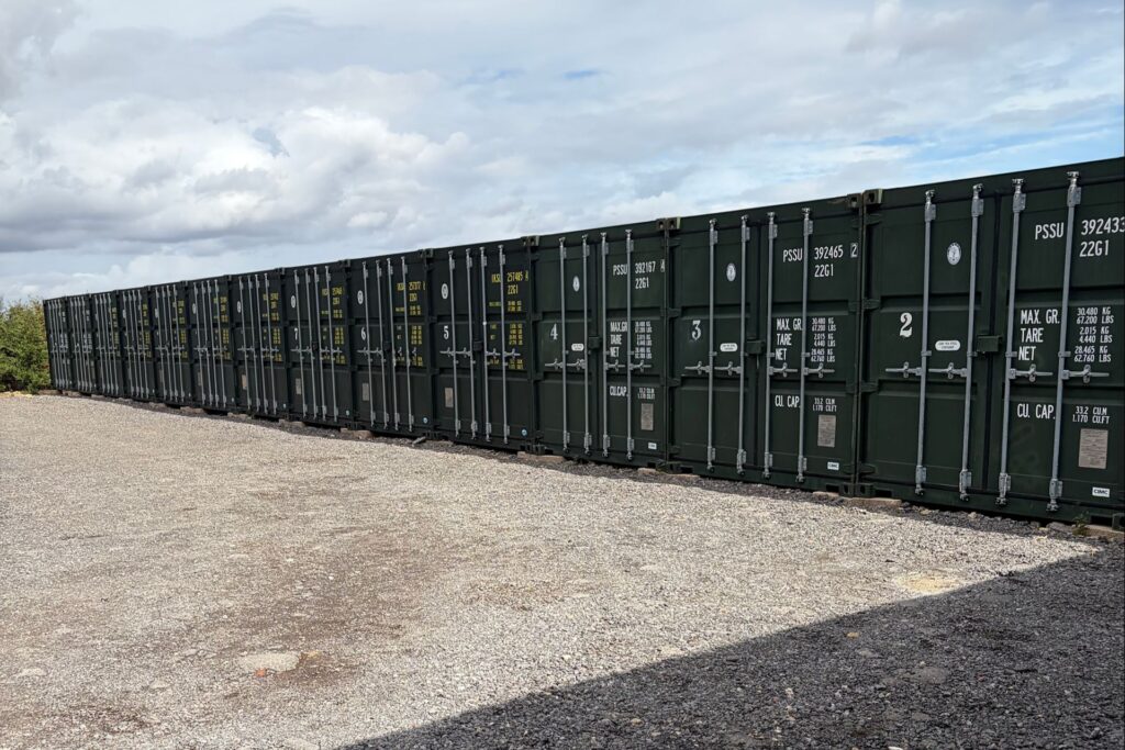 Row of numbered green storage containers with secure locking bars